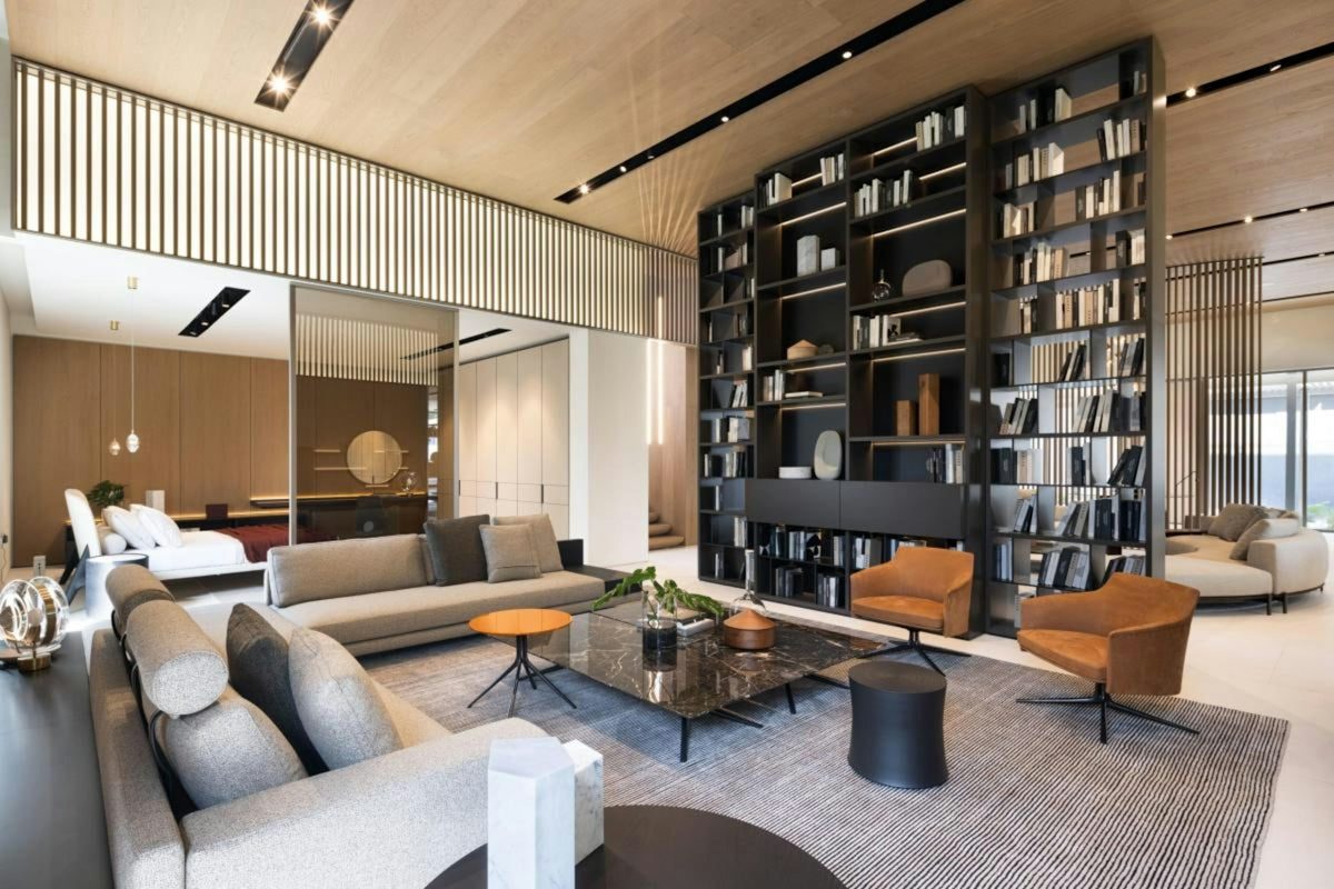 Modern living room with large bookshelf and comfortable seating