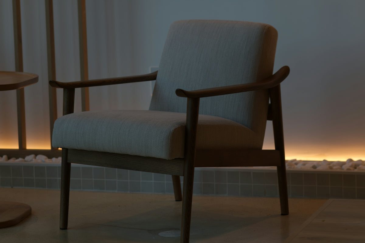 A modern armchair in a dimly lit room