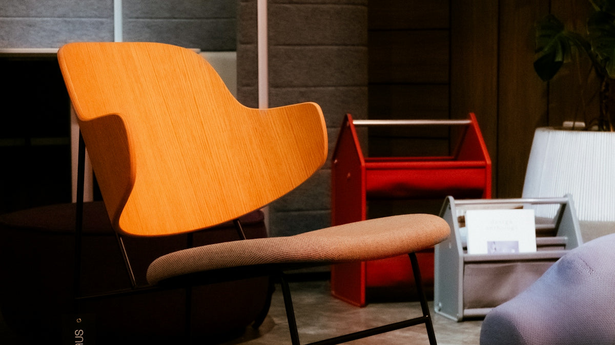A modern wooden chair with a gray cushion